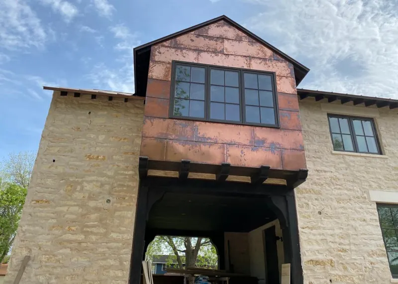 Copper metal panel facade on a stone building for Skylight Installation in Grover Beach