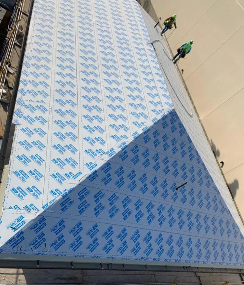 Professional roofers installing underlayment on a metal roof in Grover Beach